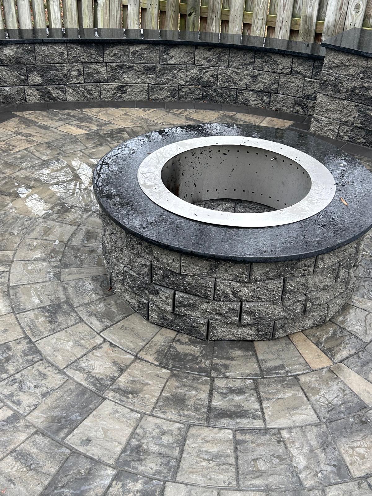 Circular paver fire-pit surround with steel ring by Kaeler